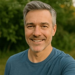 Man with gray hair wearing a blue shirt outdoors
